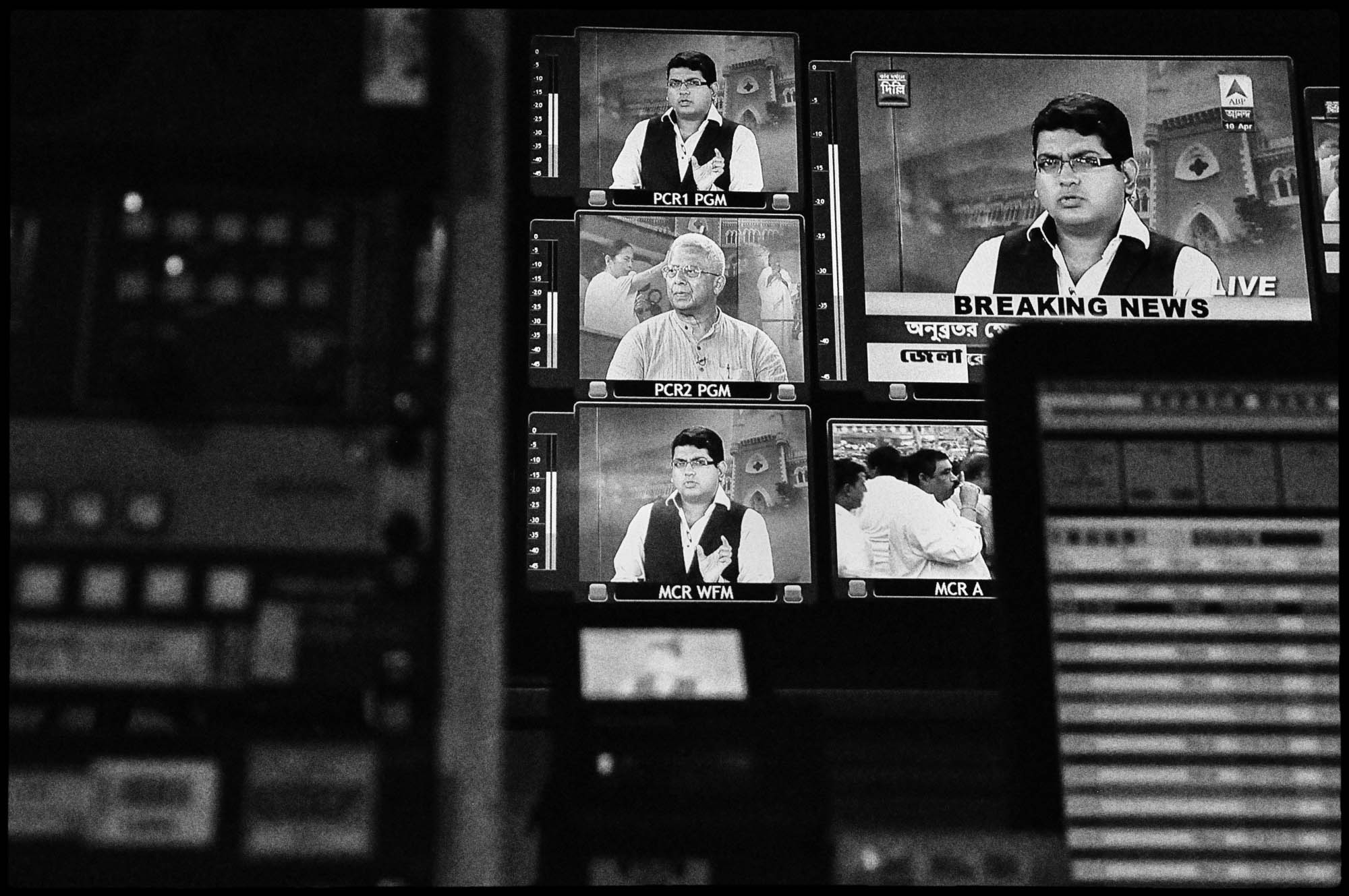 A series of televisions inside a television news channel in Kolkata