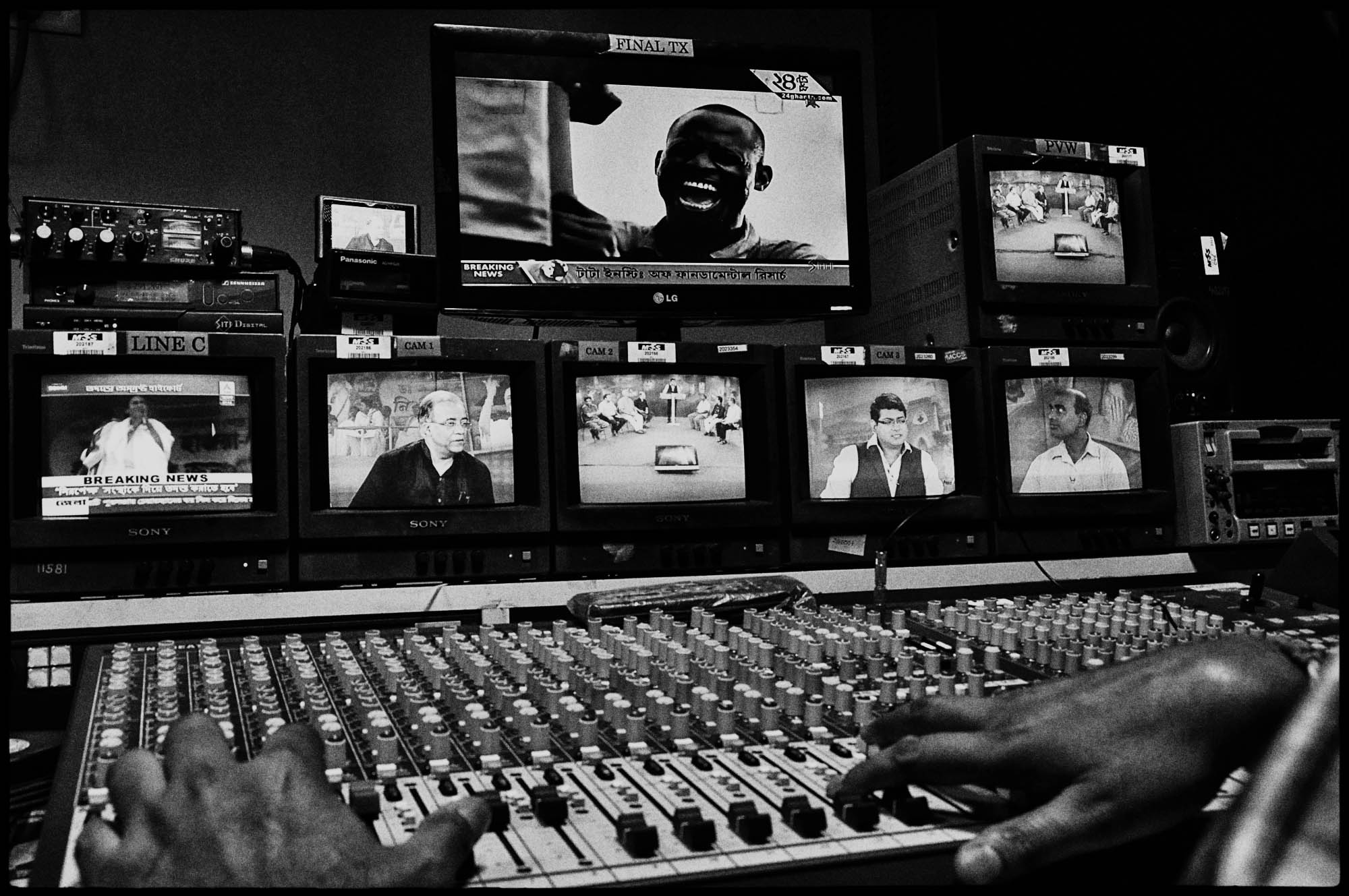 A series of televisions inside a television news channel in Kolkata